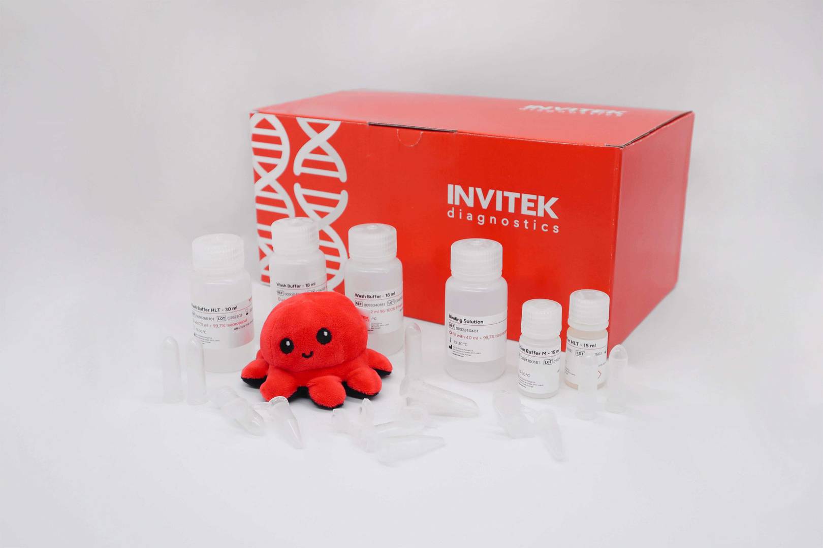 Red Invitek Diagnostics PSP SalivaGene DNA Kit box behind reagent bottles and tubes.