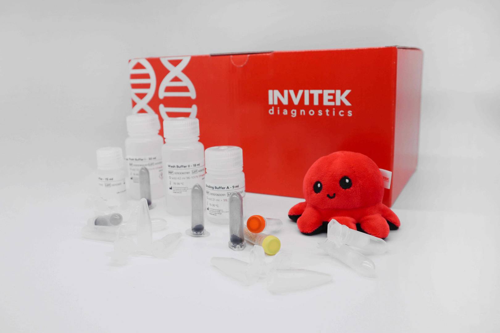 Red Invitek Diagnostics PSP Spin Stool DNA Basic Kit box with reagent bottles, colour-coded vials and tubes.