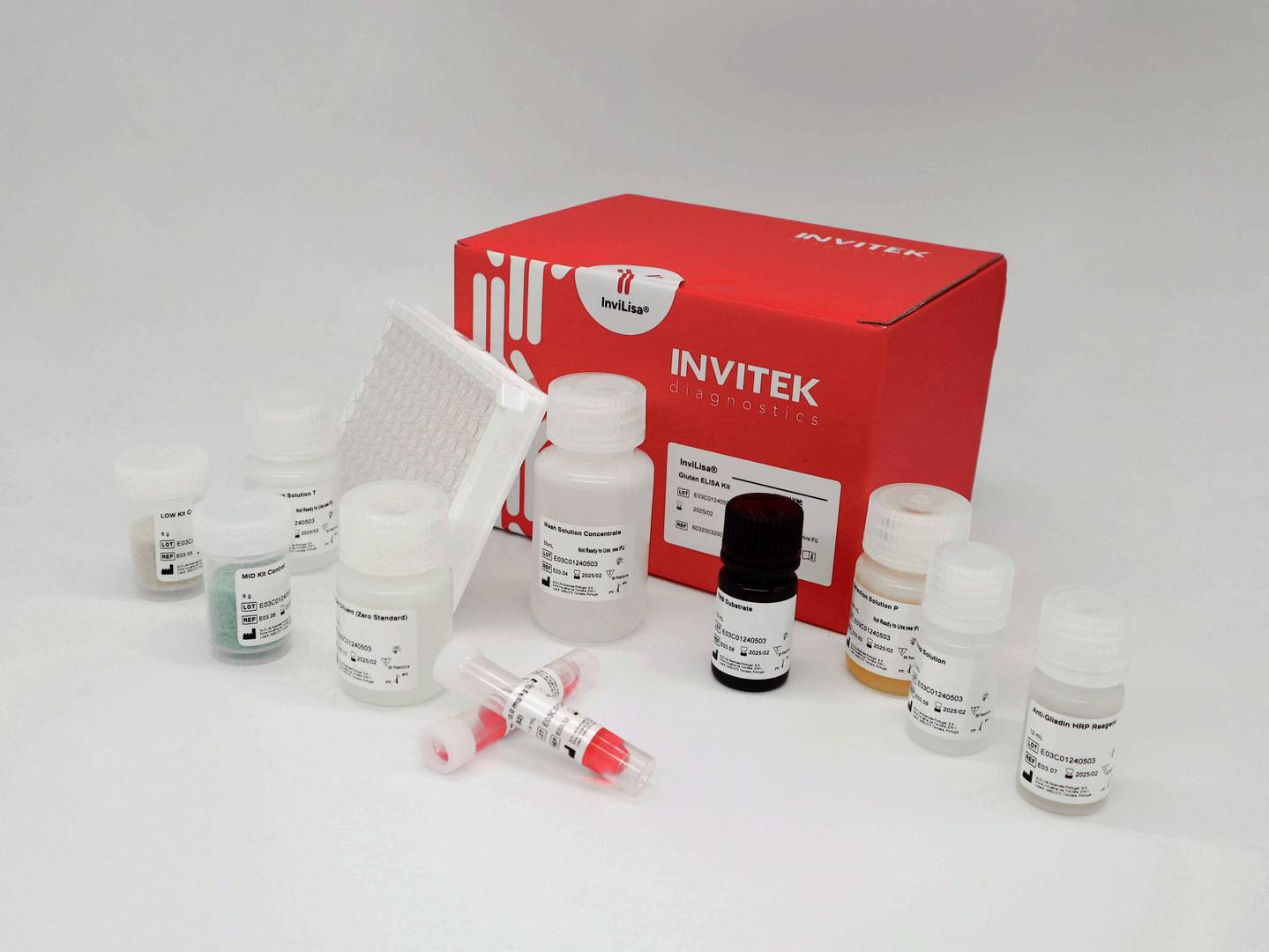 Red Invitek Diagnostics InviLisa Gluten ELISA Kit box behind multiple reagent bottles and an antibody-coated 96-well plate with reagent vials laying in front.
