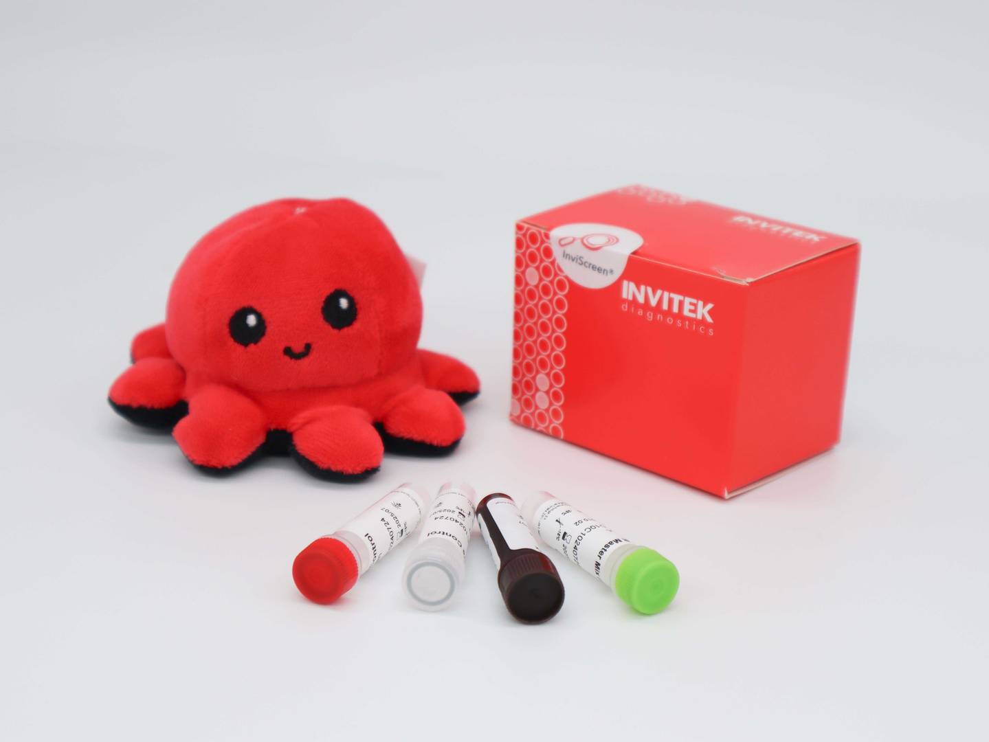 InviScreen STEC serotyping kit: similar scene—Invi mascot, red diagnostics box, and five reagent vials (red, grey, brown, green caps) across the foreground.