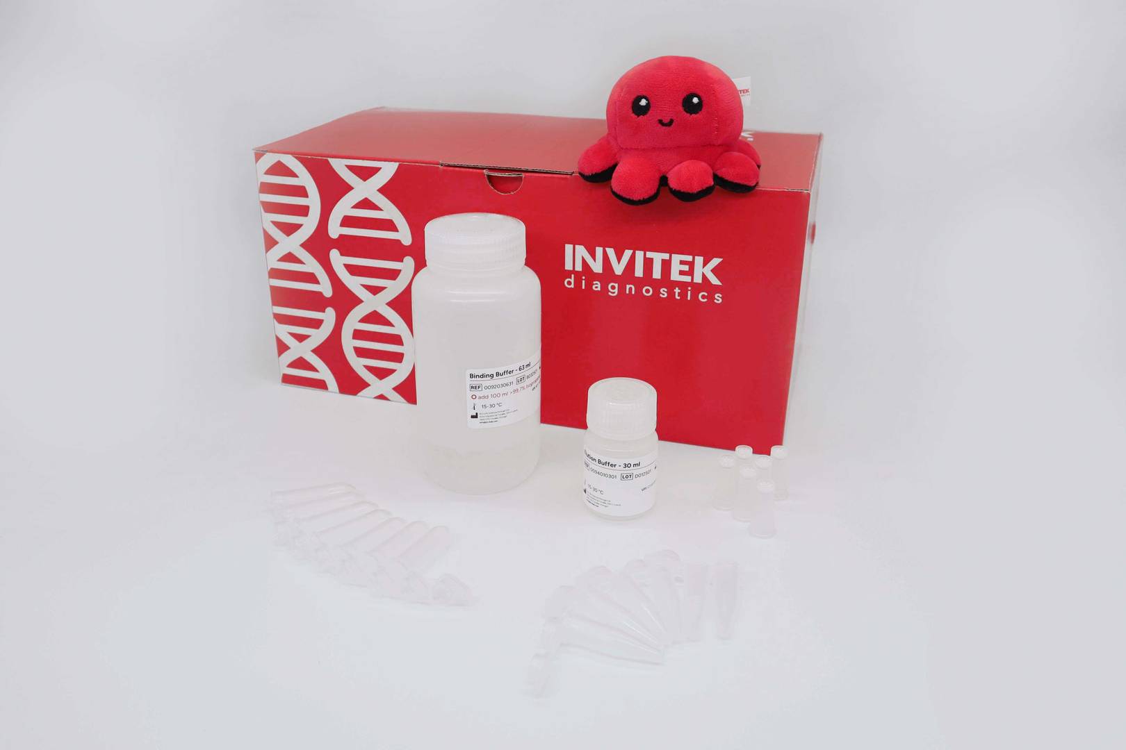 MSB Spin PCRapace kit: red INVITEK diagnostics box topped by plush octopus mascot “Invi,” with a large binding-buffer bottle, small elution-buffer vial, and clear spin columns and tube strips arranged on a white surface.