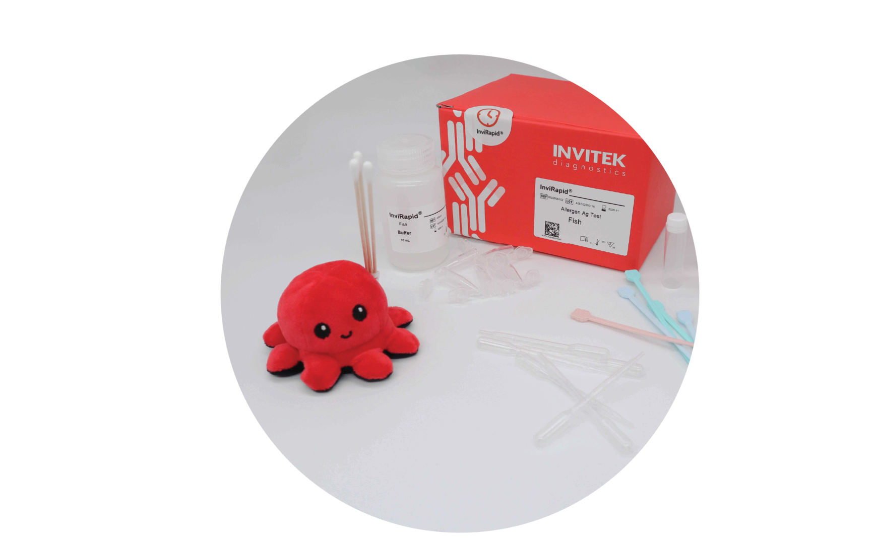 Red Invitek Diagnostics InviRapid Fish Allergen Ag Test box behind a buffer bottle and sample tubes next to swabs with scoops, droppers and tubes laying scattered in front.