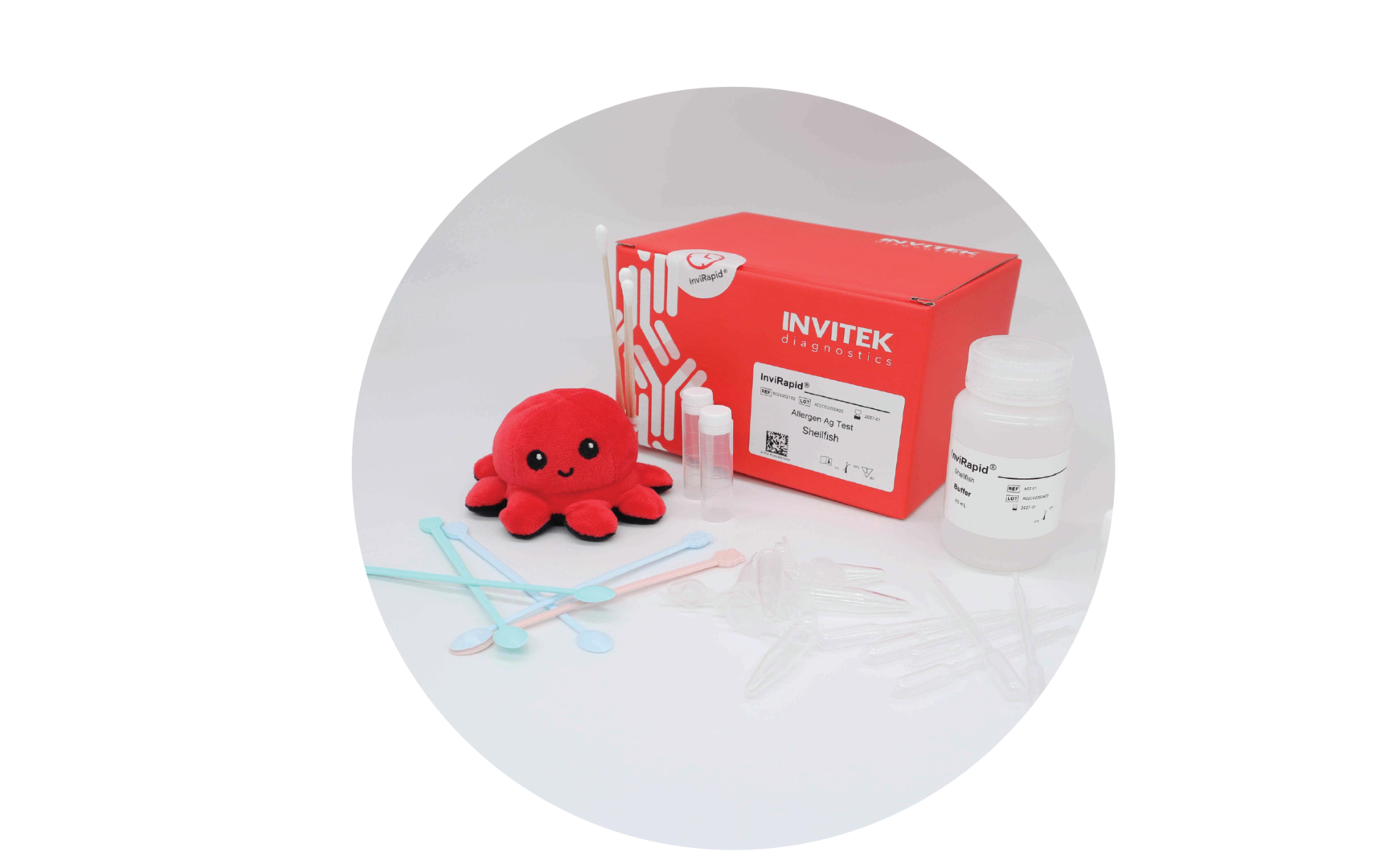 Red Invitek Diagnostics InviRapid Shellfish Allergen Ag Test box behind a buffer bottle, sample tubes, and swabs with scoops, droppers and tubes laying scattered in front.