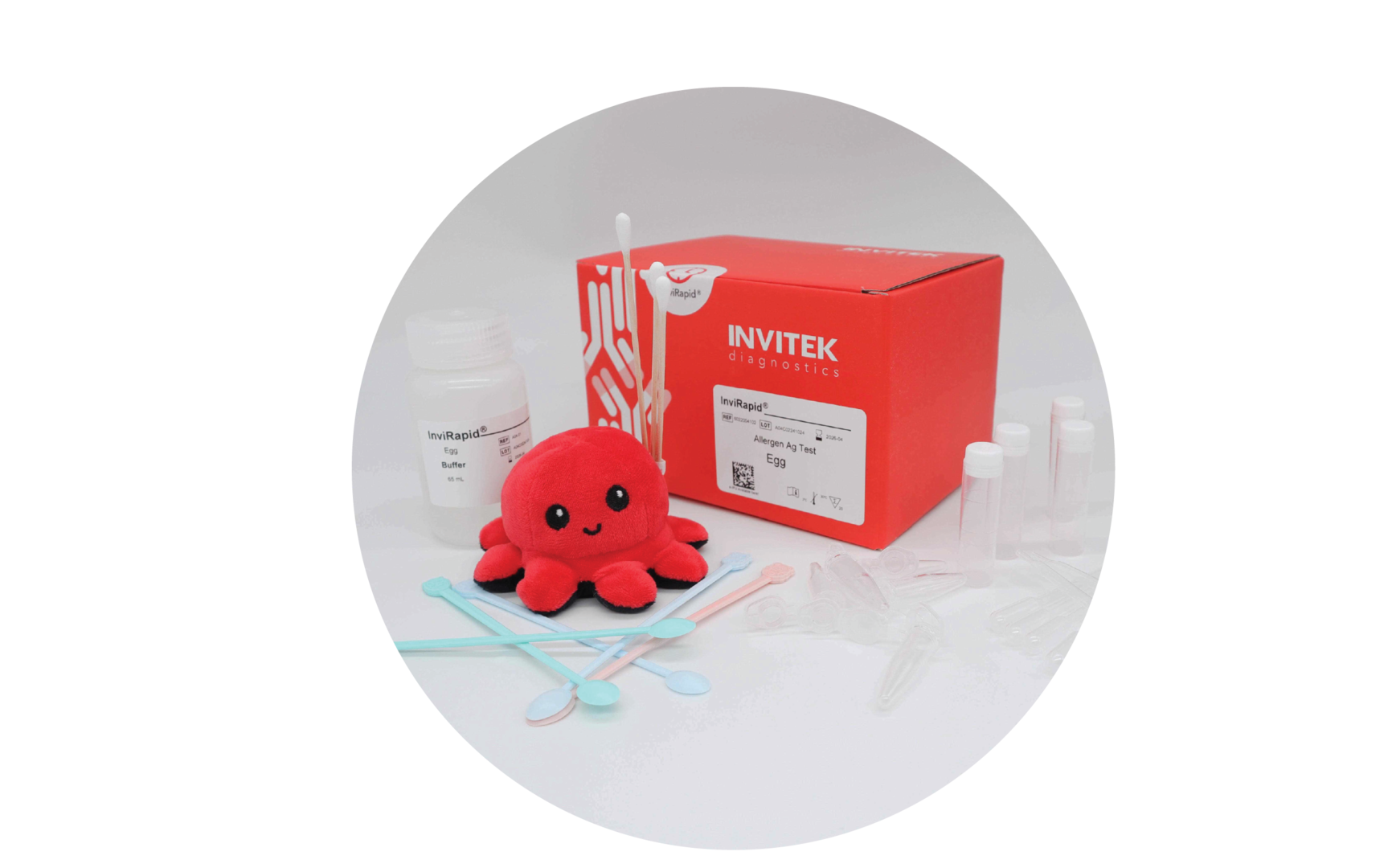 Red Invitek Diagnostics InviRapid Egg Allergen Ag Test box behind a buffer bottle, swabs, and sample tubes with scoops, droppers and tubes laying scattered in front.
