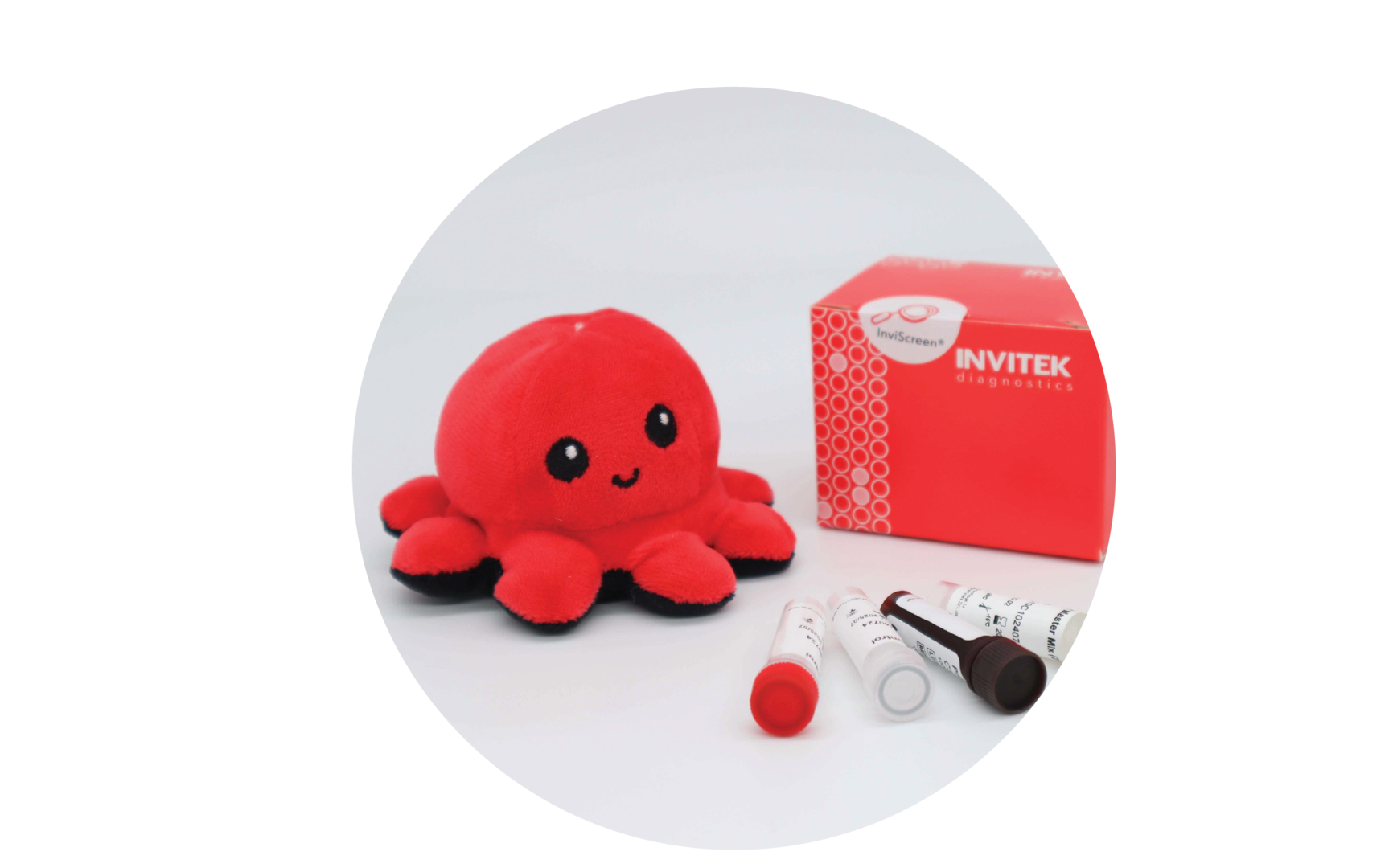 InviScreen STEC detection kit: plush octopus at left, INVITEK box at right, five reagent vials (red, grey, brown, green caps) arranged in front.