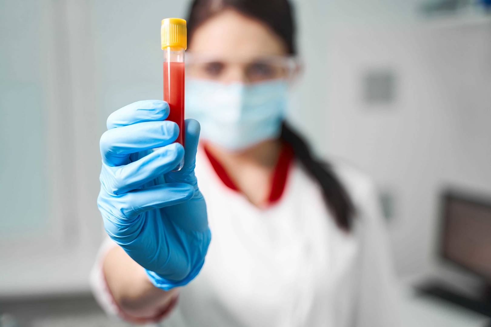 technician holding sample of blood