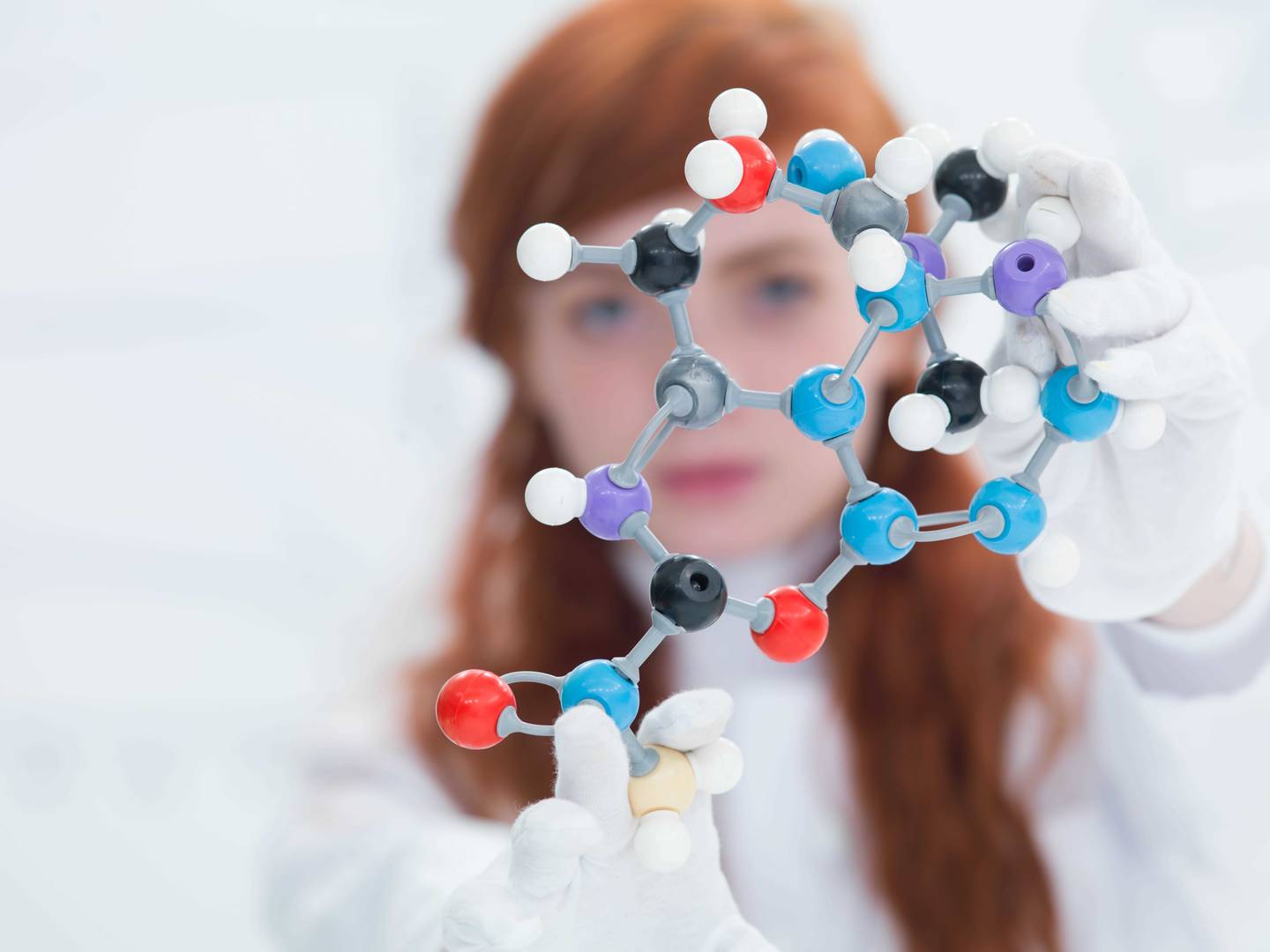 woman looking at model of oligo synthesis